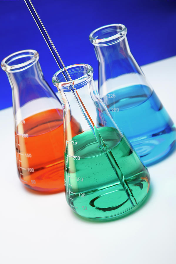 Erlenmeyer Flasks Containing Red, Green, And Blue Liquids, Representing ...