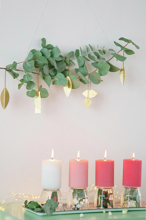 Eucalyptus Branches With Gold Pendants Above Arrangement Of Candles Photograph by Ilaria Chiaratti