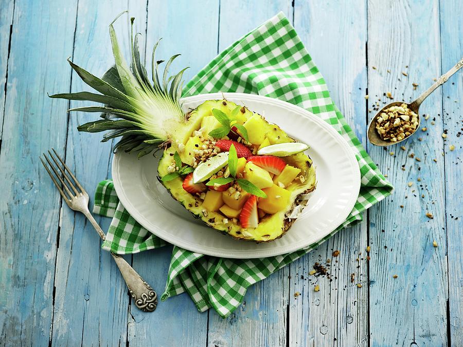 Exotic Fruit Salad Served In A Pineapple Photograph by Mikkel Adsbl