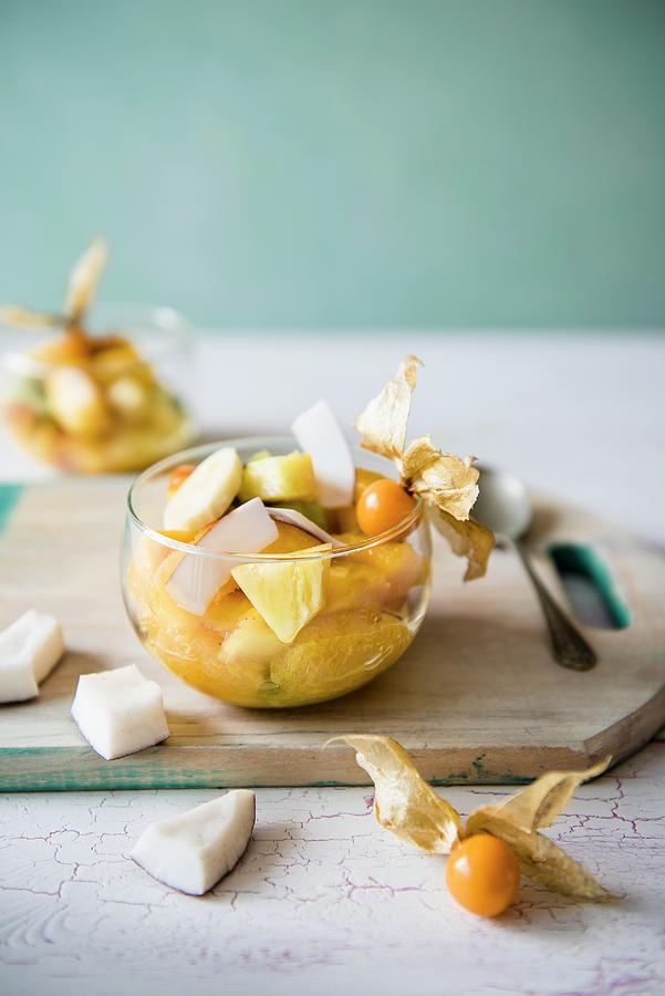 Exotic Fruit Salad With Mango, Coconut, Pineapple, Banana, Orange And Kiwi In A Glass Bowl Photograph by Magdalena Hendey