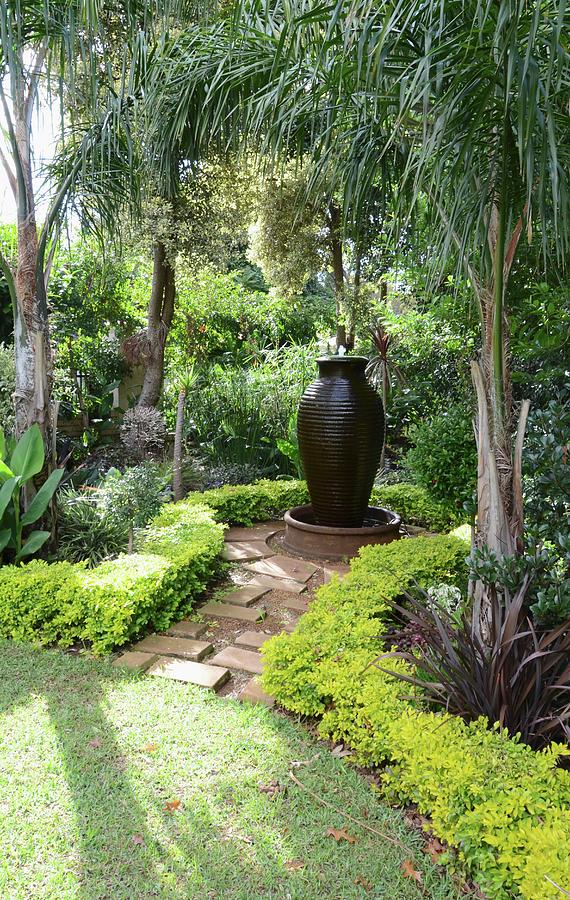 Exotic Gardens With Amphora-shaped Fountain Below Palm Trees Photograph by Great Stock!