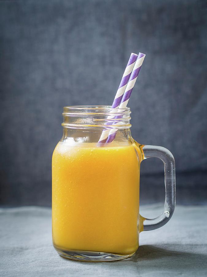 Exotic, Yellow Fruit Smoothie In A Glass Jar With A Paper Straw Photograph by Magdalena Paluchowska