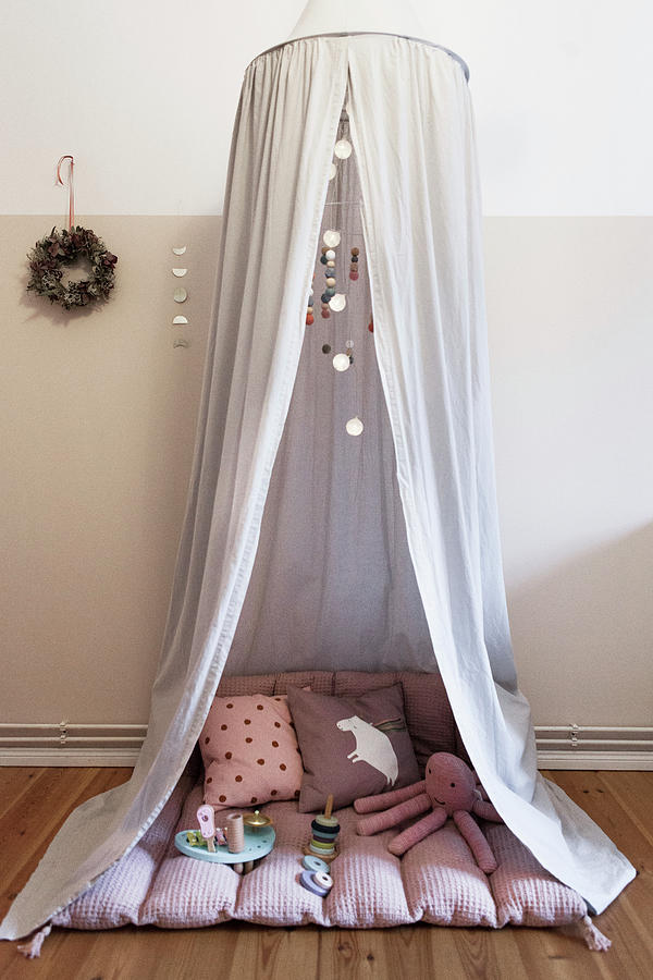 Fabric Canopy Over Blanket, Cushions And Toys In Childs Bedroom Photograph by Hej.hem Interior