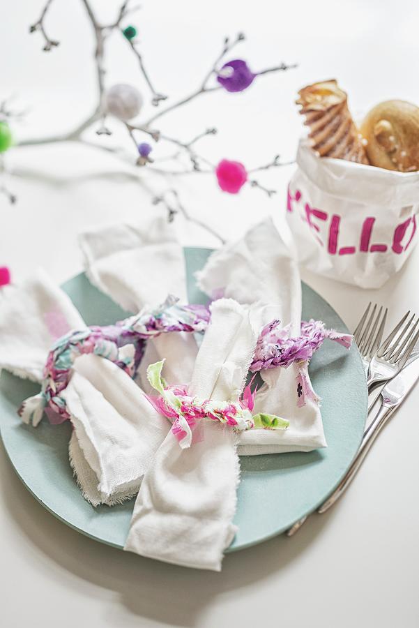 Fabric Remnants Used As Decorative Ribbons For Linen Napkins In Front Of Hand-made Fabric Bread Bag Decorated With Motto hello Photograph by Patsy&christian