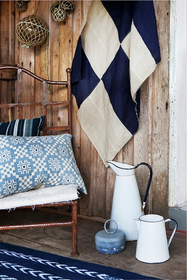 Fabrics In Various Patterns Of Blue And White And Old Enamel Jugs On Wooden Terrace Photograph by Annette Nordstrom