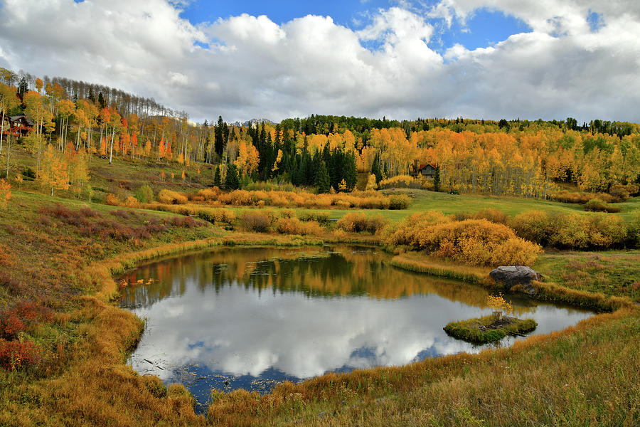 Fall Colors and Clouds Reflected in Mountain Village Pond Photograph by Ray Mathis