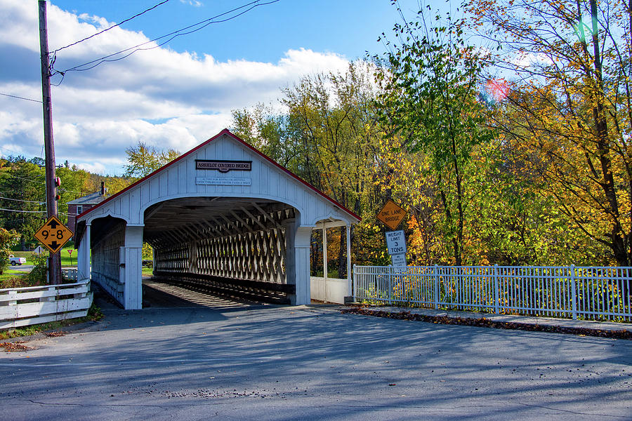 Fall colors over Ashuelot Covered Bridge Photograph by Jeff Folger