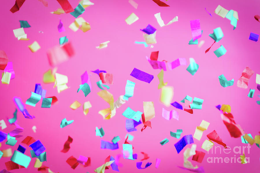 Falling confetti on pink background. 