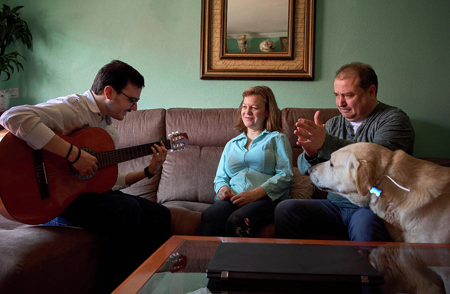Music Photograph - Family Having Fun While Theyre Playing The Guitar And Singing At Home by Cavan Images