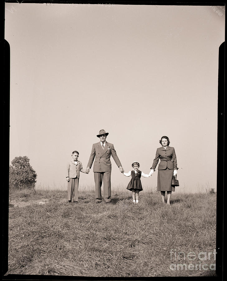 Family Holding Hands In Open Field Photograph by Bettmann