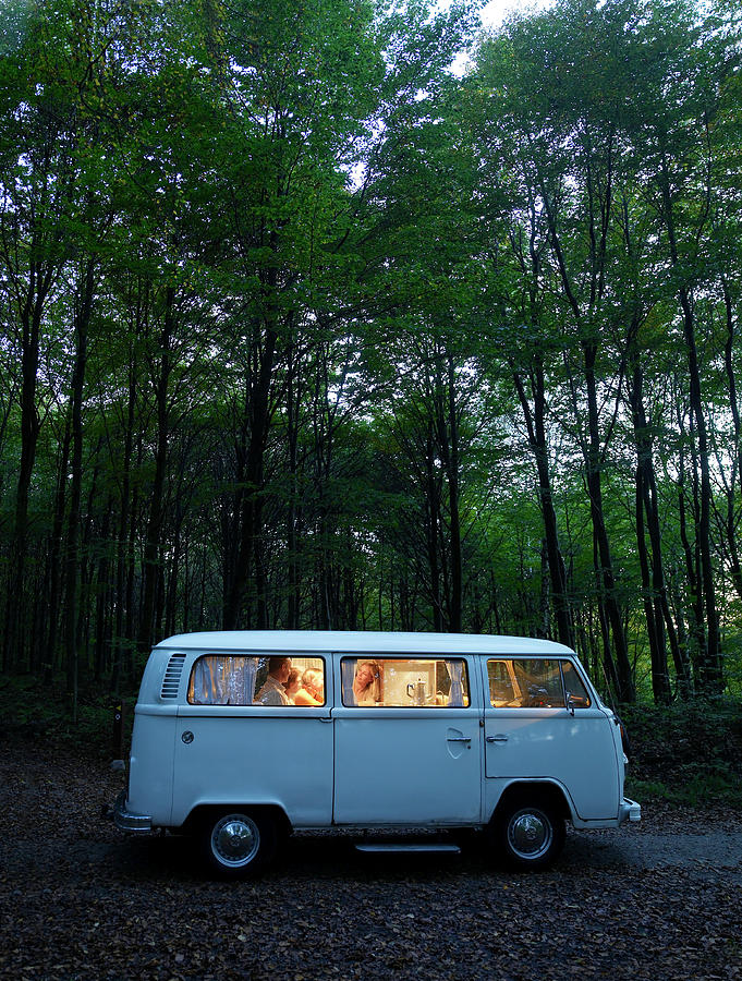 Family In Illuminated Van In Forest Photograph by Jakob Helbig