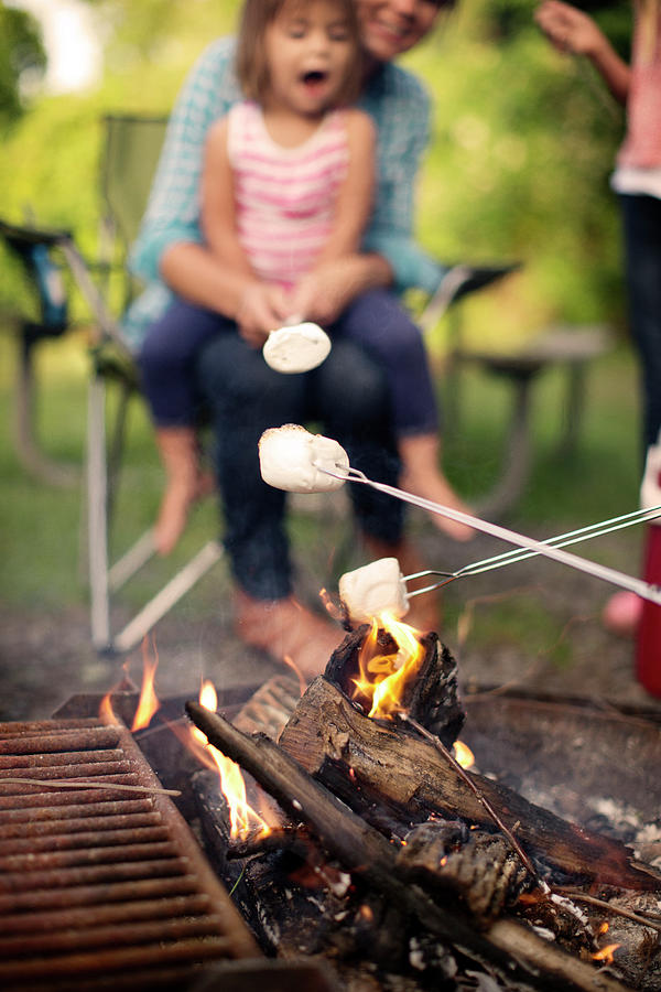 Marshmallow Photograph - Family Roasting Marshmallows While Camping In Forest by Cavan Images