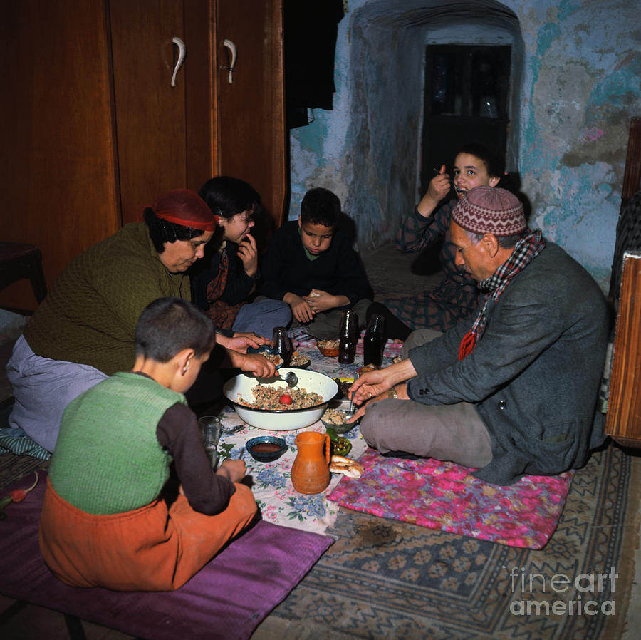 Family Sitting On Floor And Eating Photograph by Bettmann