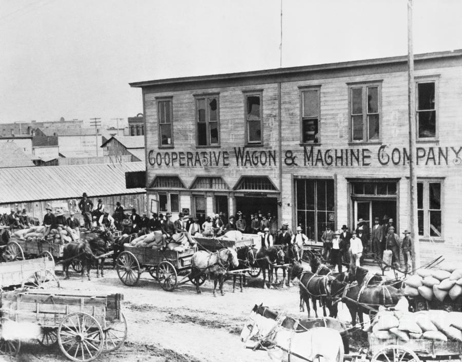 Farmers Delivering Loads Of Grain by Bettmann