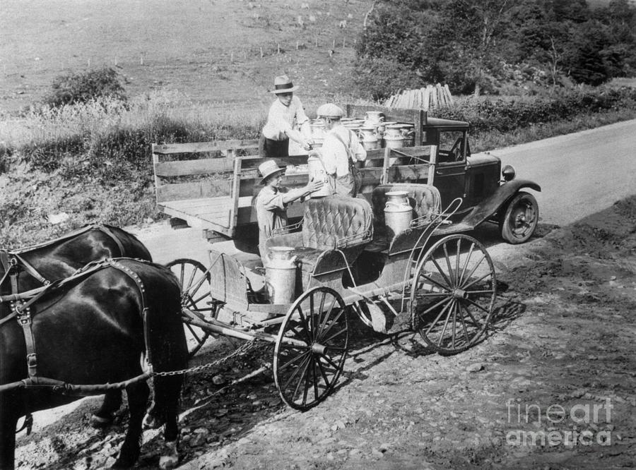 Farmers Handing Milk Cans To Delivery Photograph by Bettmann