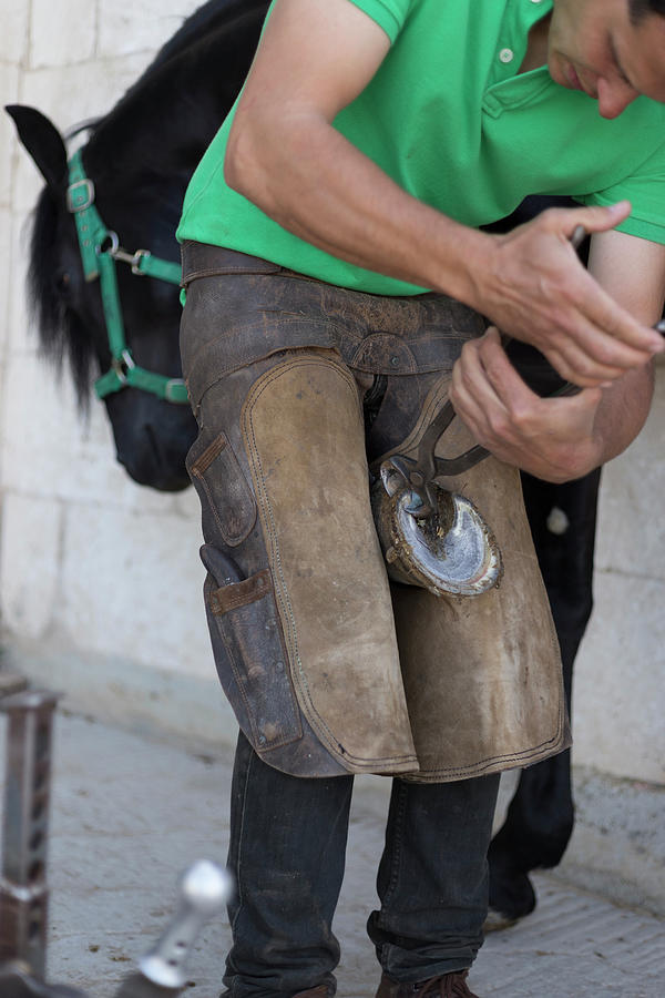 Tool Photograph - Farrier Bending Down Horse Shoe by Cavan Images