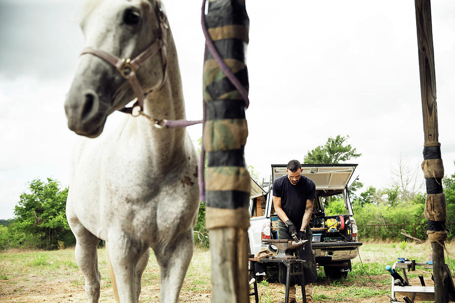 Transportation Photograph - Farrier Making Horseshoe While Standing On Field By Pick-up Truck by Cavan Images