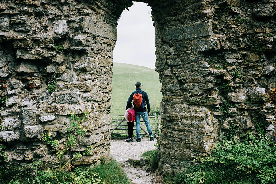 Architecture Photograph - Father And Daughter Exploring An English Castle Together Happily by Cavan Images