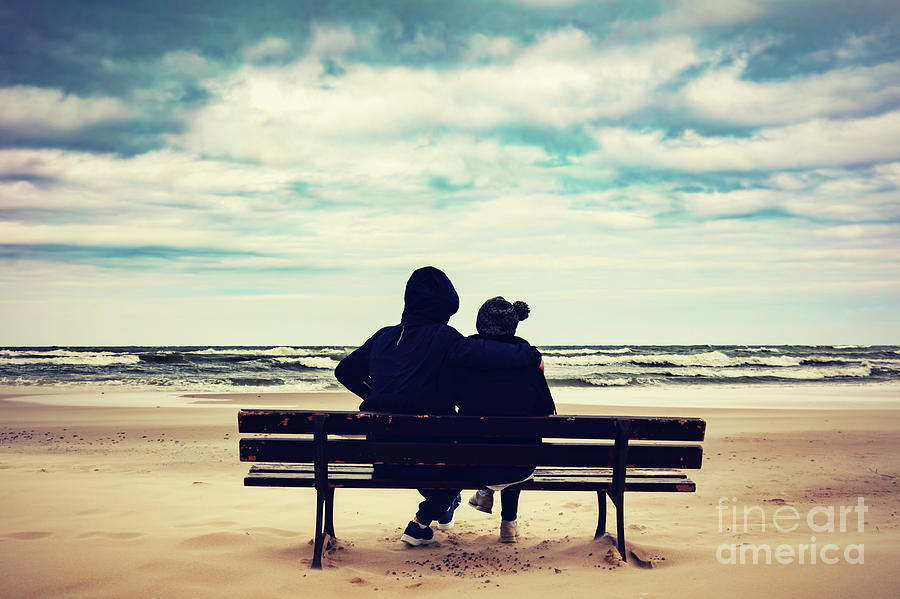 Father and daughter sitting on a bench on the beach Photograph by Michal Bednarek