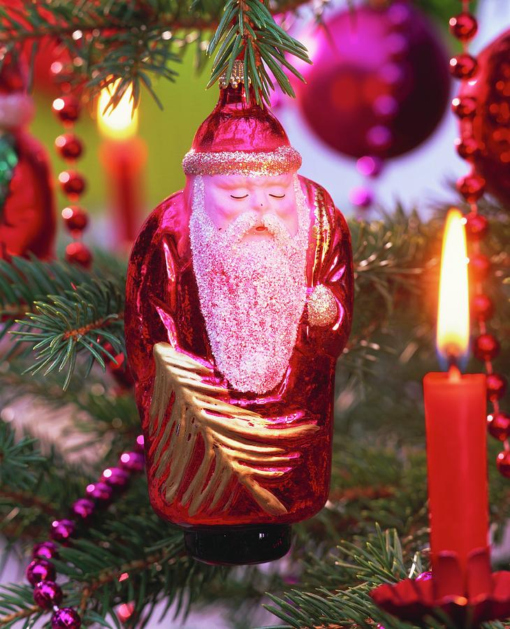 Father Christmas And Burning Candle On Christmas Tree Photograph by Friedrich Strauss