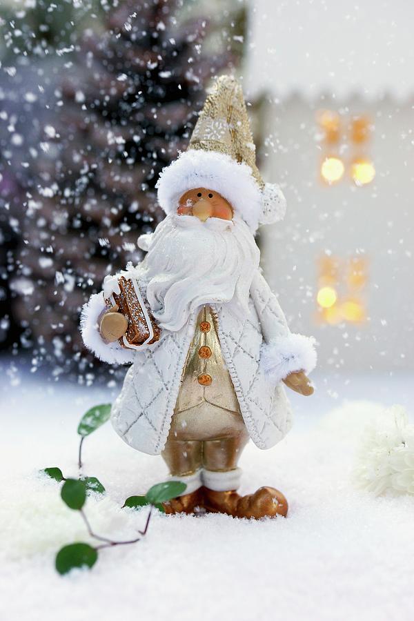 Father Christmas Ornament On Artificial Snow Photograph by Angelica Linnhoff