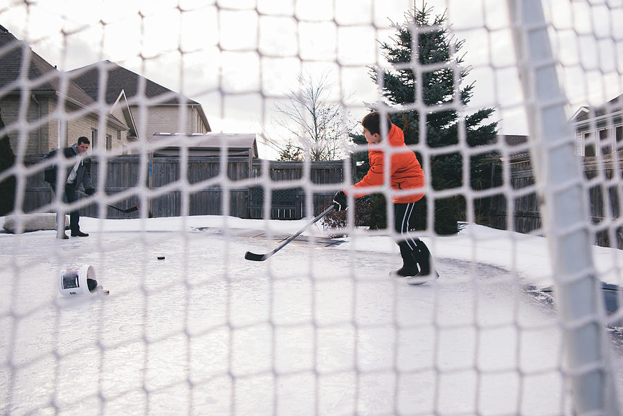 Father With Son Playing Ice Hockey At Yard Photograph by Cavan Images ...