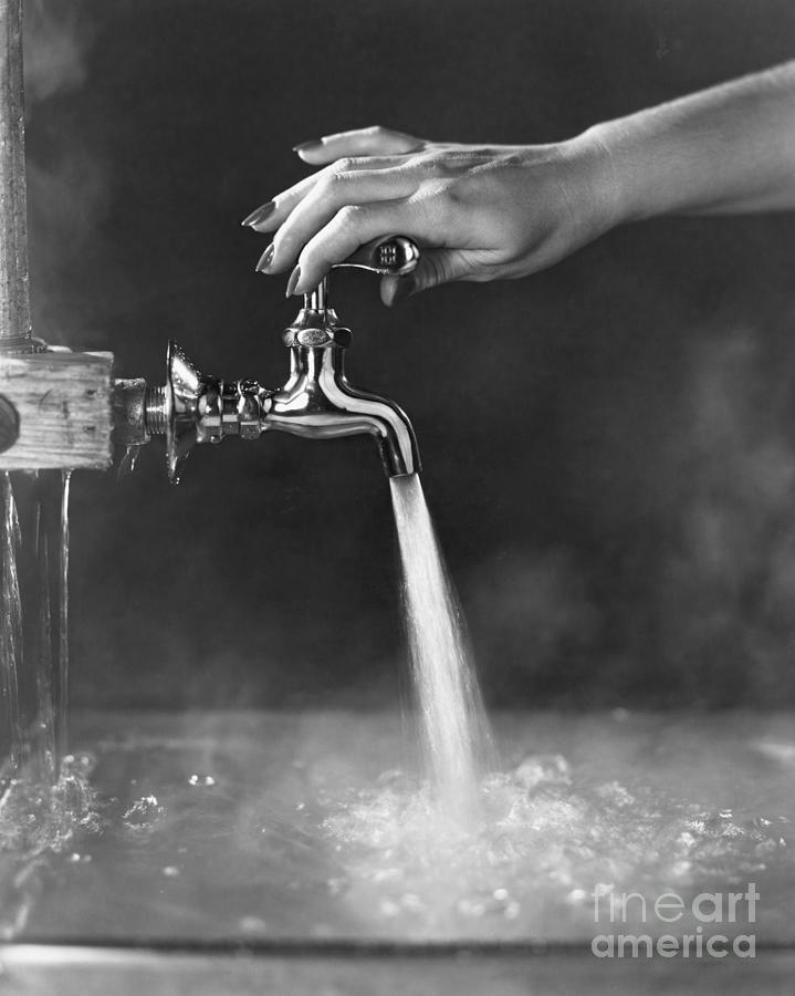 Faucet Being Adjusted By Womans Hand Photograph by Bettmann