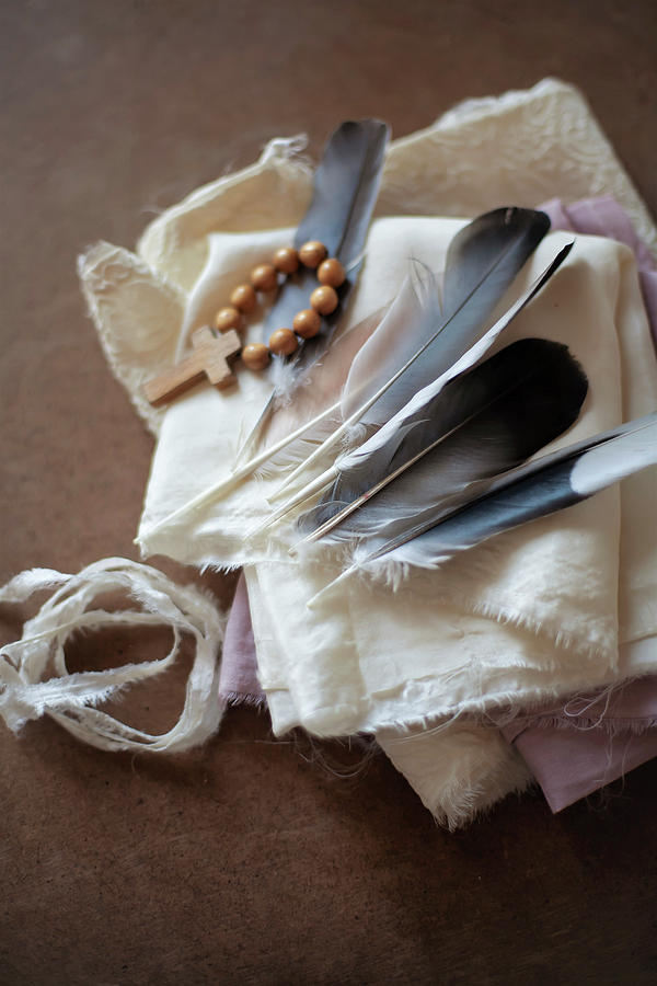 Easter Photograph - Feathers And Cross On Wooden Beads On White Cloth by Alicja Koll
