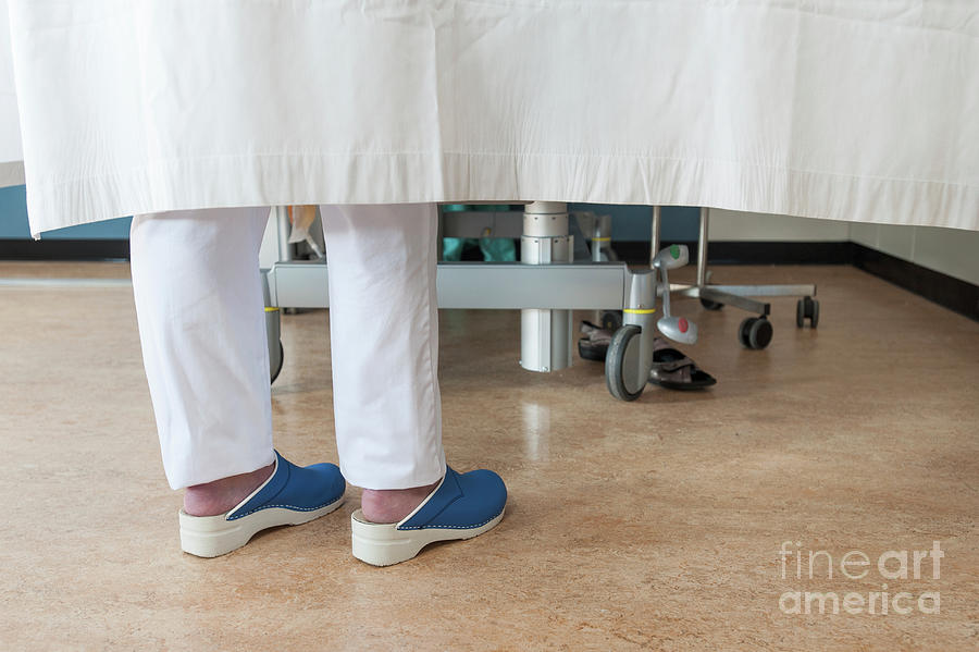 Feet Of A Nurse At A Patients Bedside Photograph by Arno Massee/science Photo Library