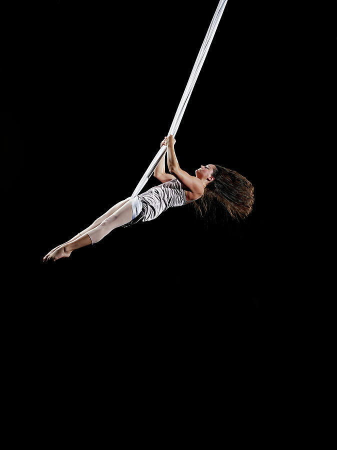 Female Aerialist Swinging On Suspended Photograph by Thomas Barwick