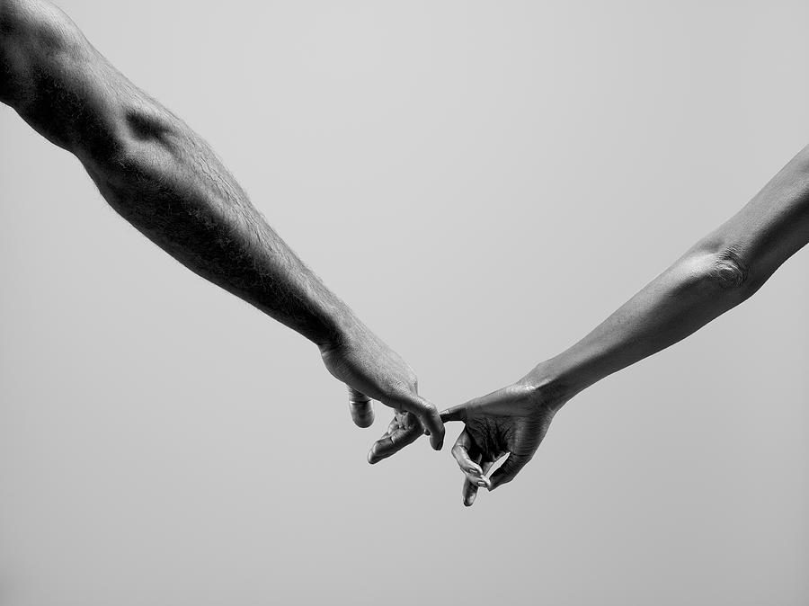 Black And White Photograph - Female And Male Connecting By Fingers by Jonathan Knowles