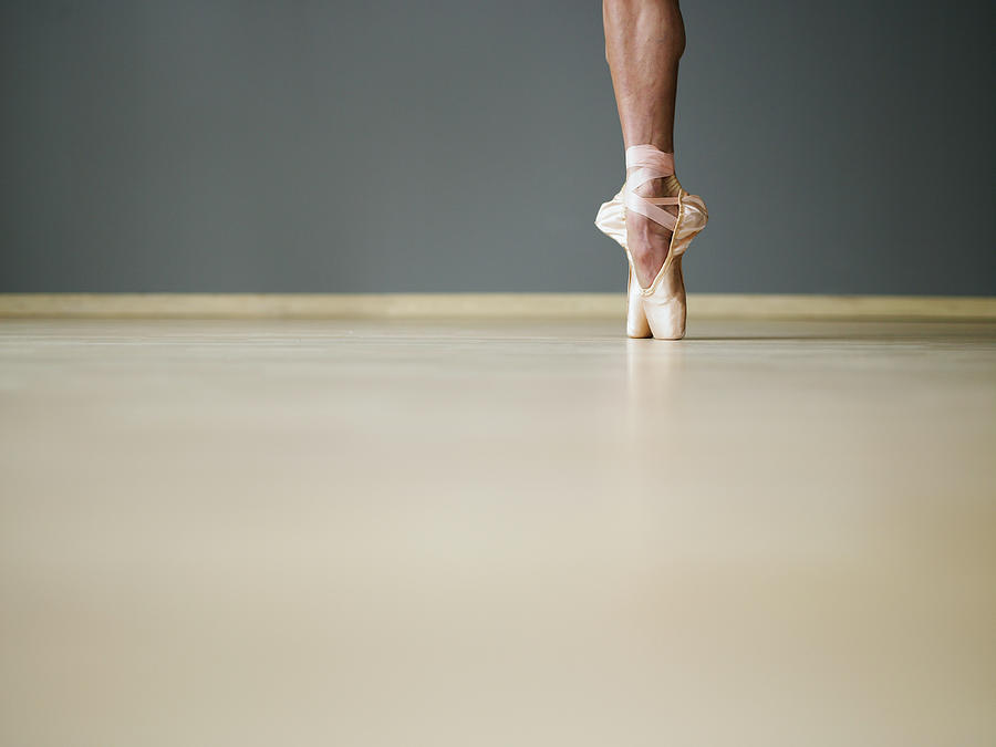 Female Ballerina Standing On Toes In Photograph by Thomas Barwick