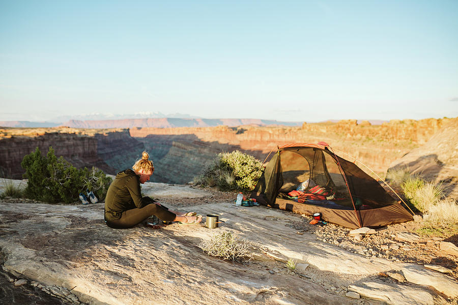 Female Camper Prepares Food Next To Campsite Overlooking Grand Canyon ...