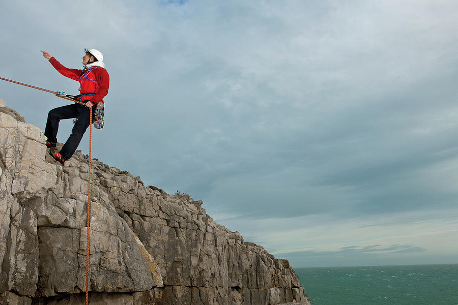 Descending Photograph - Female Climber Rappelling Of Seacliff In Swanage / England by Cavan Images