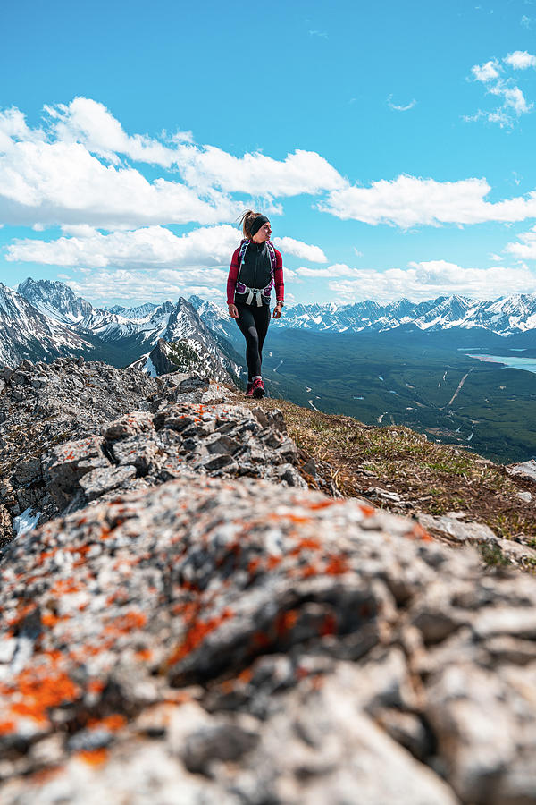 Female Hiking On Mountain Summit Above Nearby Mountain Peaks Photograph ...