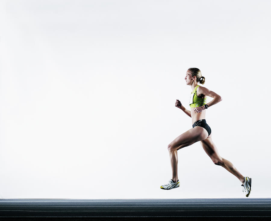 Female Runner On Track Photograph by Thomas Barwick