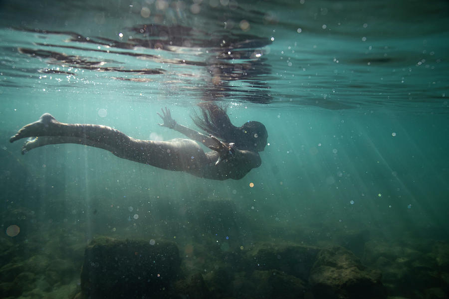 Female Swims Away Under The Surface Of The Clear, Shallow Ocean ...