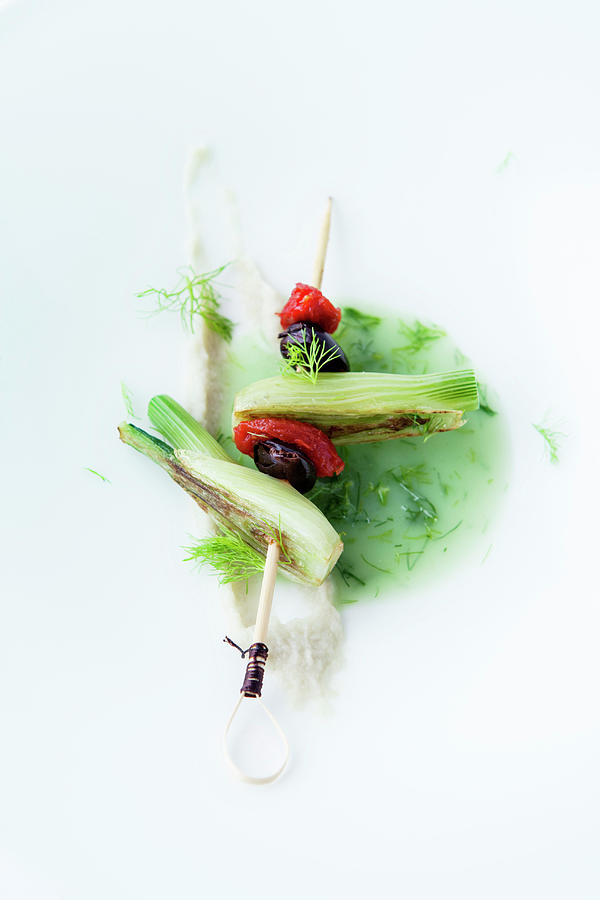 Fennel Broth With A Skewer Of Fennel, Tomato And Olive Photograph by Michael Wissing