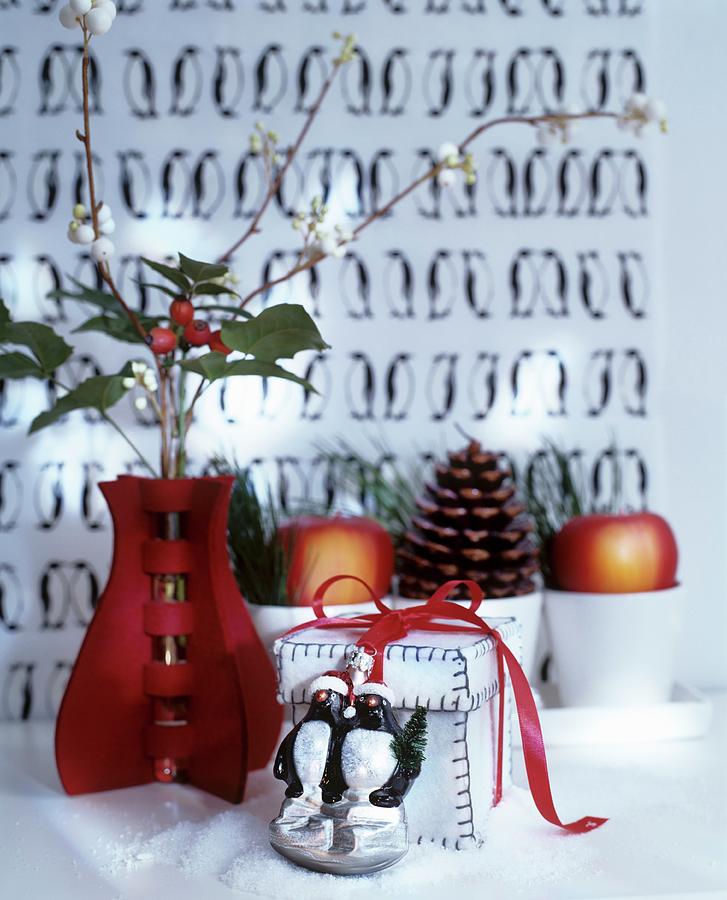 Festive Arrangement Of Red Vase, Gift Box And Animal Figurine Photograph by Matteo Manduzio