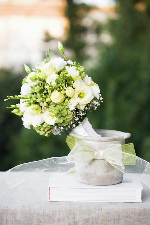 Festive Bouquet Of White Flowers In Concrete Pot Decorated With Ribbon Photograph by Alicja Koll