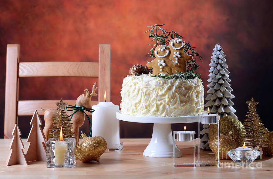 Festive Christmas white chocolate cake with gingerbread men cook Photograph by Milleflore Images