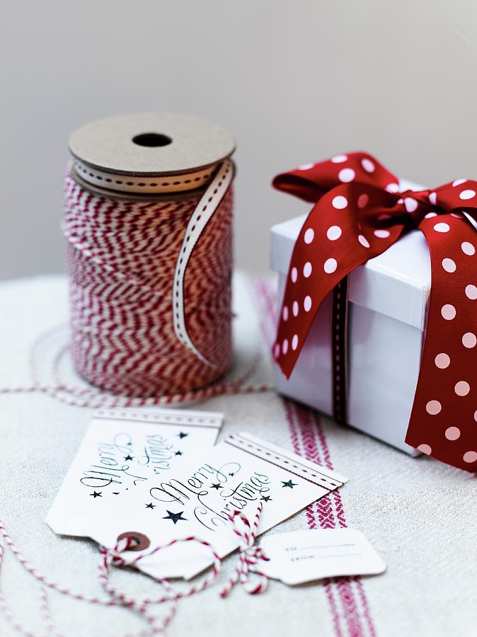 Festive Gift Tags, Ribbon And Gift Box Photograph by Catherine Gratwicke