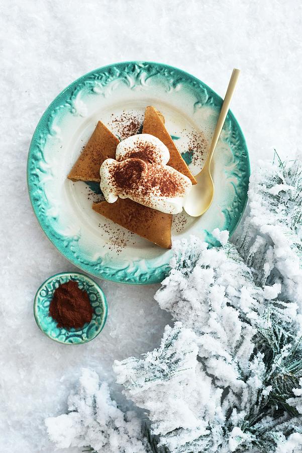 Festive Gingerbread Cake With Whipped Cream On A Plate In The Snow Photograph by Veronika Studer