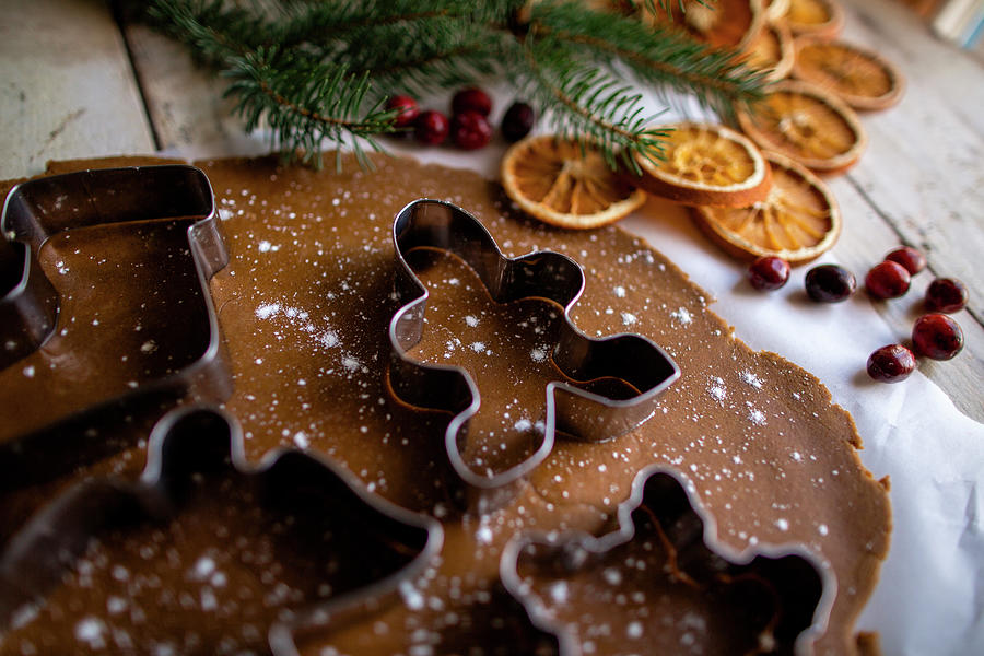 Christmas Photograph - Festive Gingerbread High Side Angle Shot Of Cookie Cutter On Dough by Cavan Images