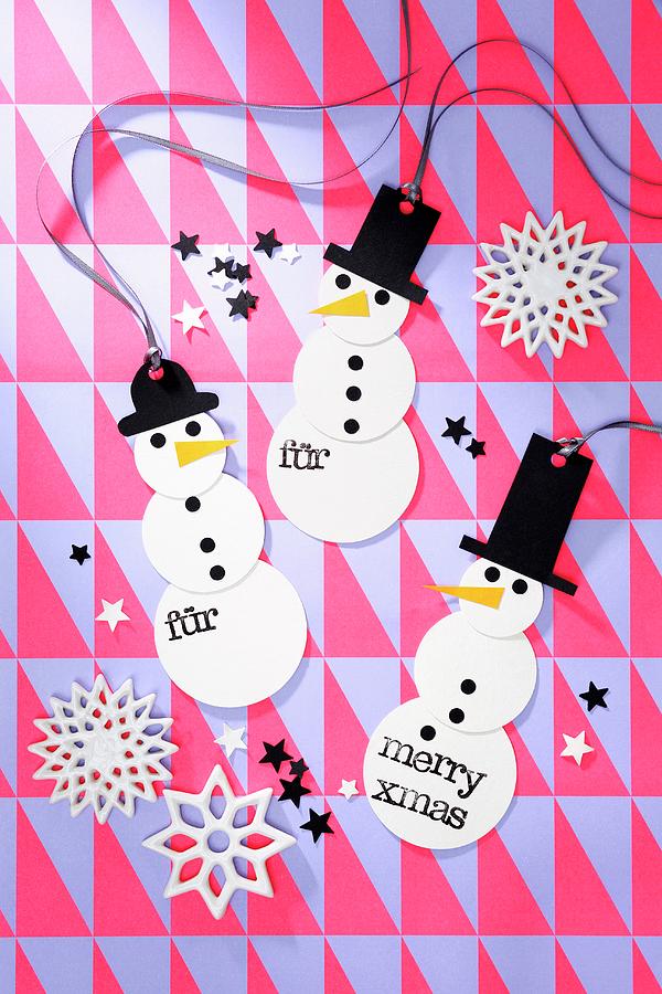 Festive, Hand-made Snowman Decorations On Geometric Wrapping Paper Photograph by Thordis Rggeberg