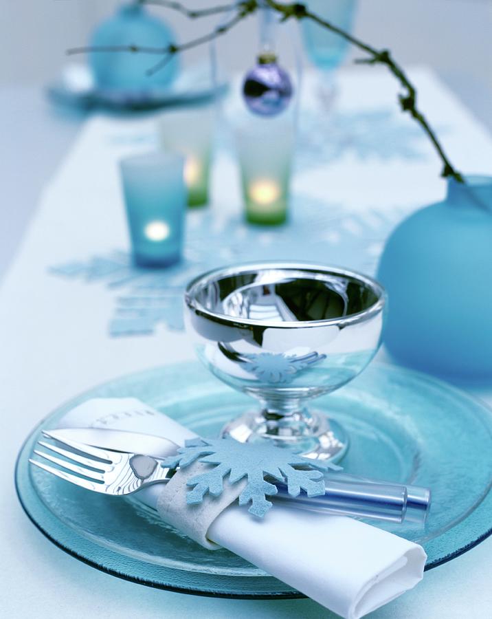 Festive Place Setting With Ice-blue Glass Plates, Shiny Goblet And Felt Napkin Ring Photograph by Matteo Manduzio