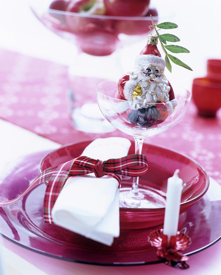 Festive Place Setting With Red Glass Dishes Embellished With Christmas Tree Decorations Photograph by Matteo Manduzio