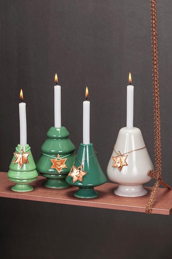 Festive, Suspended Arrangement Of Four Advent Candles On Copper-coloured Board Photograph by Studio27neun
