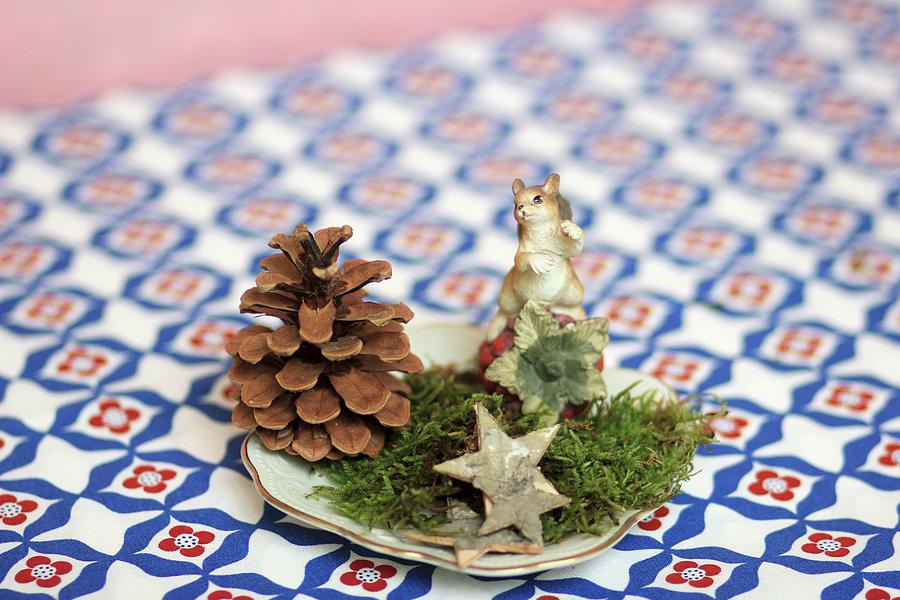 Festive Table Decoration Of Pine Cone, Moss, Star And Animal Ornament Photograph by Ruth Laing