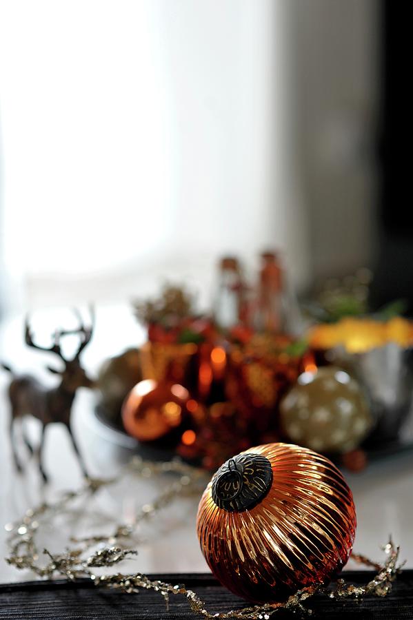 Festive Table Decoration With Christmas Tree Baubles And Stag Figurine Photograph by Alexandra Feitsch